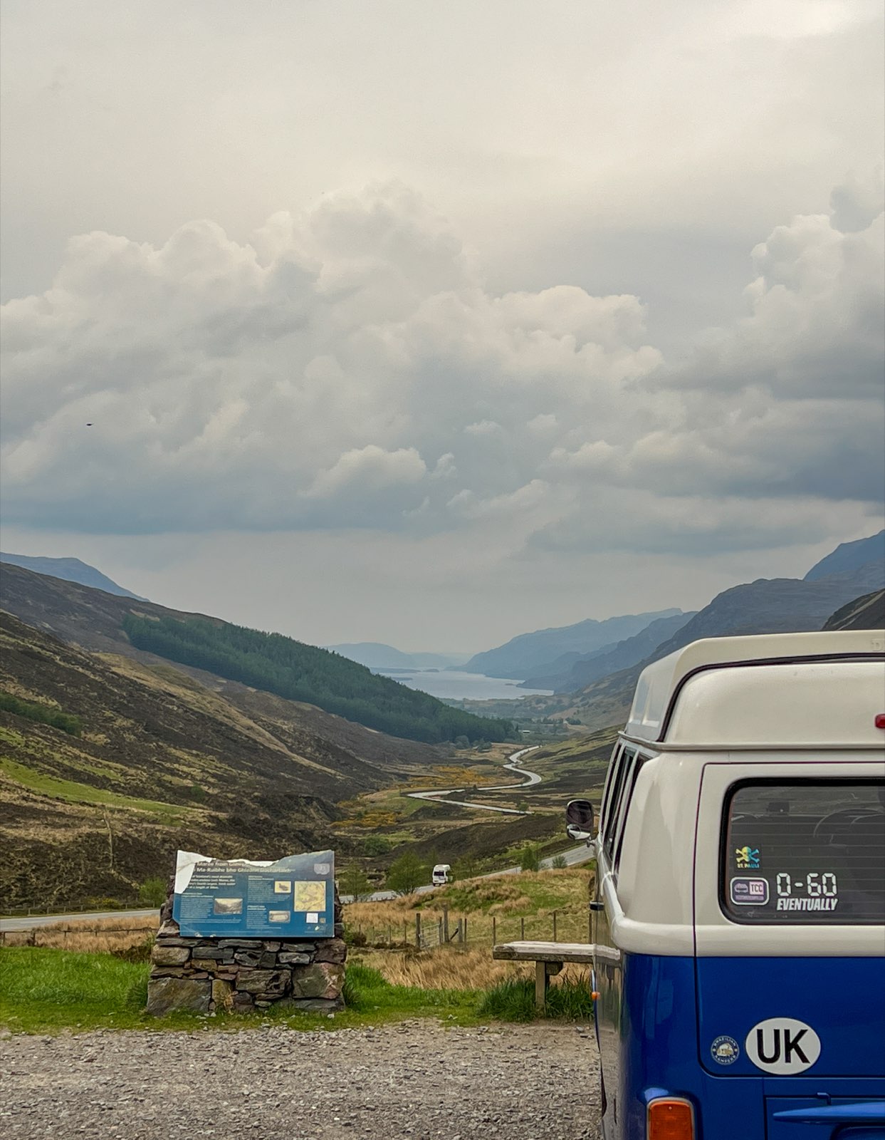 The van parked on a hillside above a valley